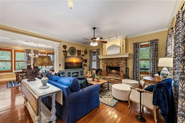 a living room with furniture a fireplace and a chandelier
