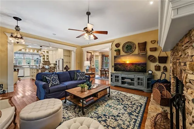 a kitchen with refrigerator a stove and a wooden floor