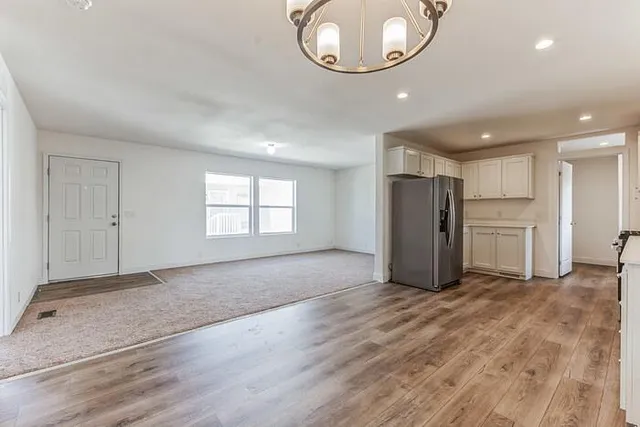 a view of an empty room and a window