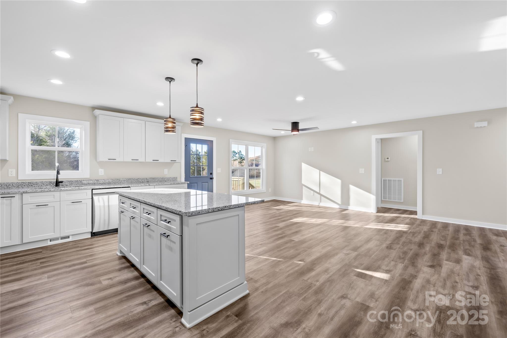 177 Monticello Road Statesville, NC 28625 - Photo 11 of 39 a large kitchen with granite countertop a stove oven and a sink