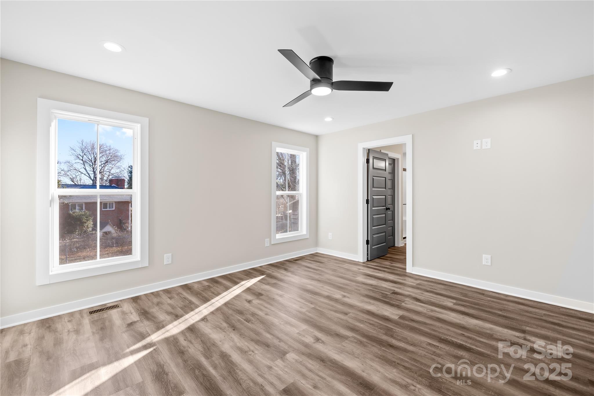 177 Monticello Road Statesville, NC 28625 - Photo 13 of 39 a view of an empty room with a window and wooden floor