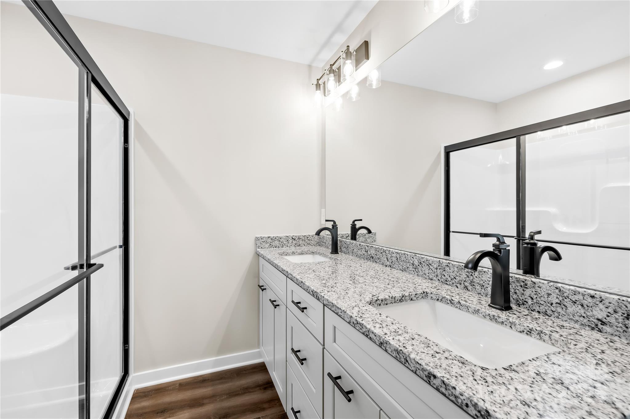 177 Monticello Road Statesville, NC 28625 - Photo 16 of 39 a bathroom with a granite countertop sink and a mirror