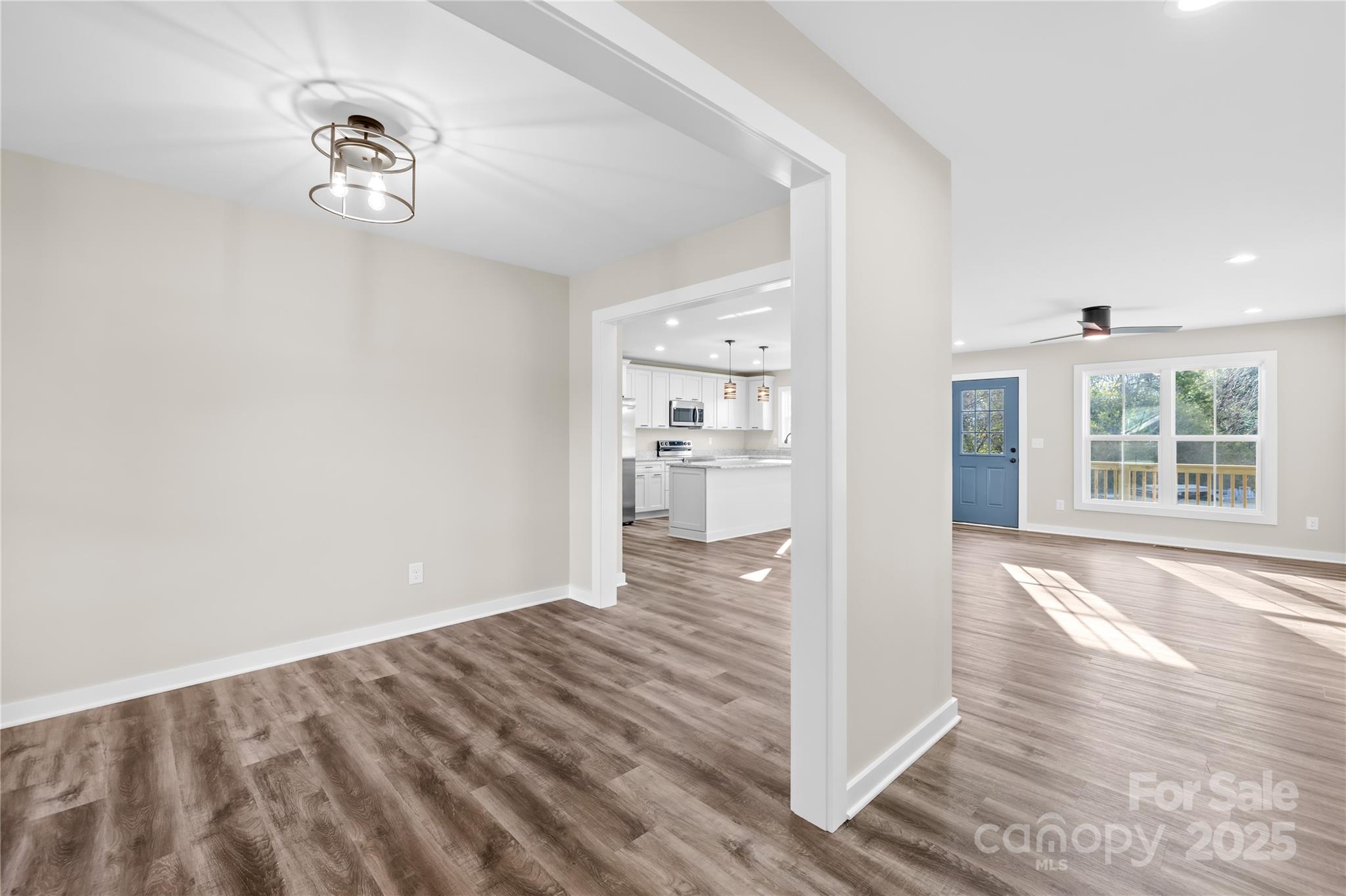 177 Monticello Road Statesville, NC 28625 - Photo 3 of 39 a view of a hallway with wooden floor and a kitchen space