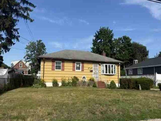 330 Amerigo Vespucci Avenue Copiague, NY 11726 - Photo 1 of 3 a front view of a house with a yard