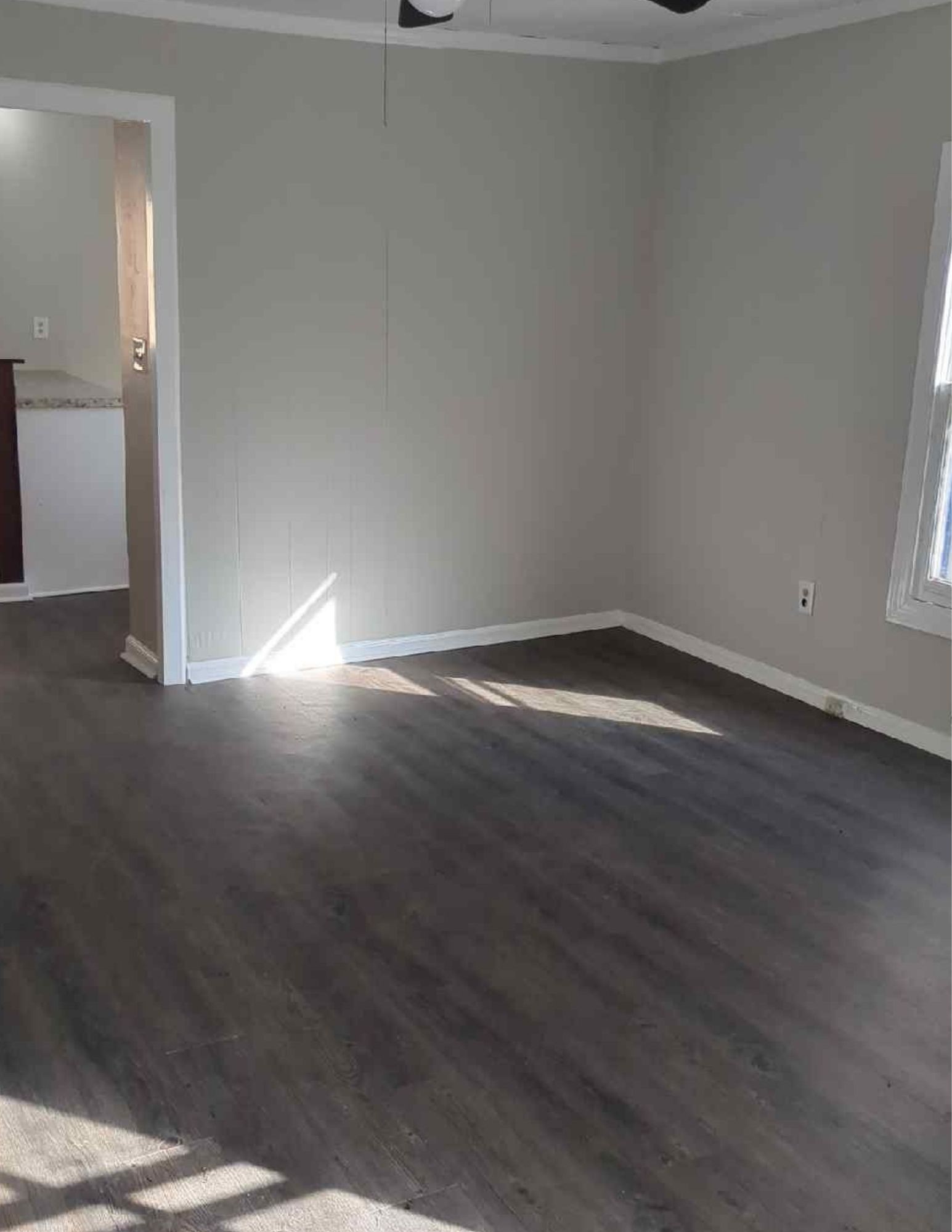 6684 Cavender Road Lyles, TN 37098 - Photo 4 of 13 an empty room with wooden floor and windows