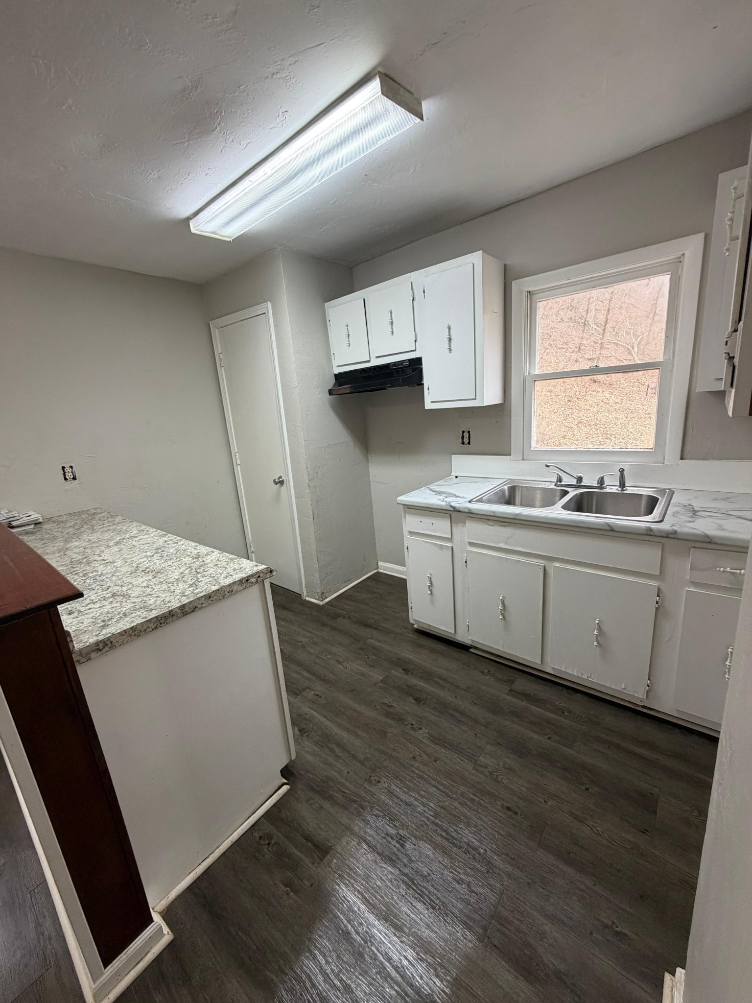 6684 Cavender Road Lyles, TN 37098 - Photo 6 of 13 a kitchen with a sink stove and cabinets