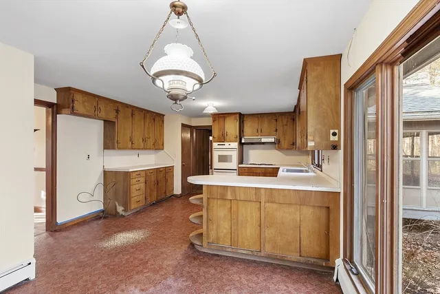 a kitchen with granite countertop a sink stove and refrigerator