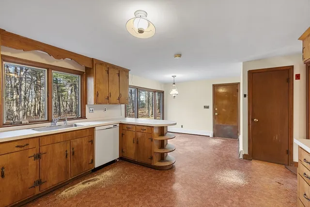 a kitchen with a sink window and cabinets