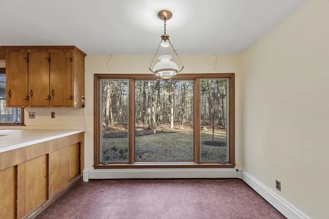 a view of an empty room with glass door and fan