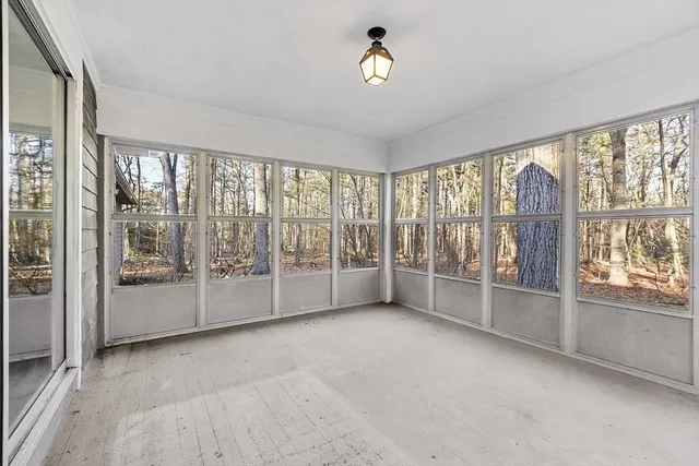a living room with furniture and a large window with outer view