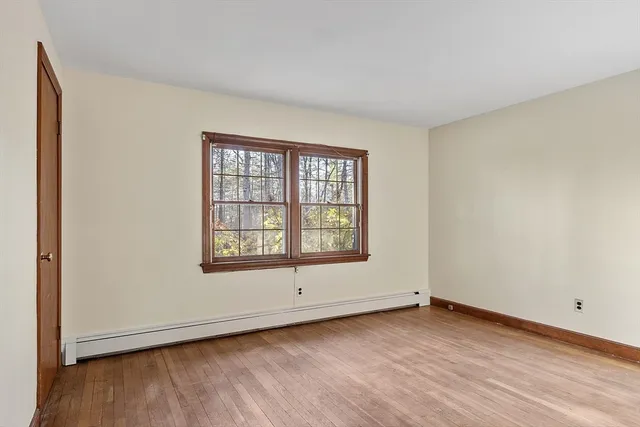 an empty room with windows and closet