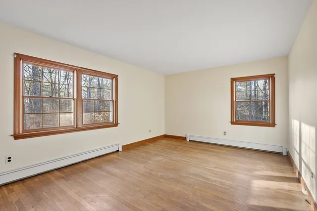an empty room with windows and closet
