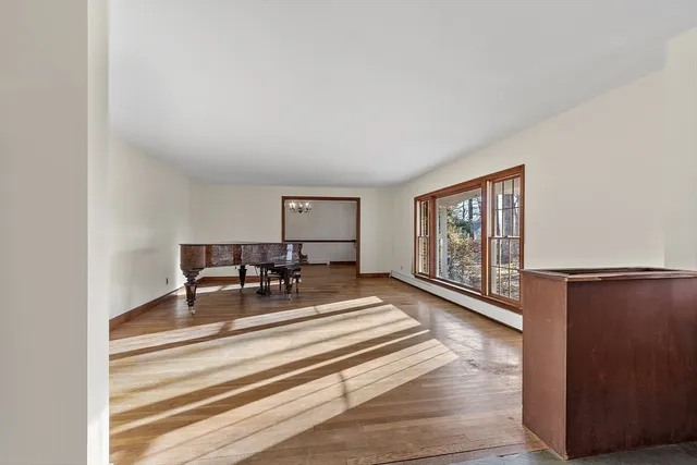 a view of a livingroom with wooden floor and furniture