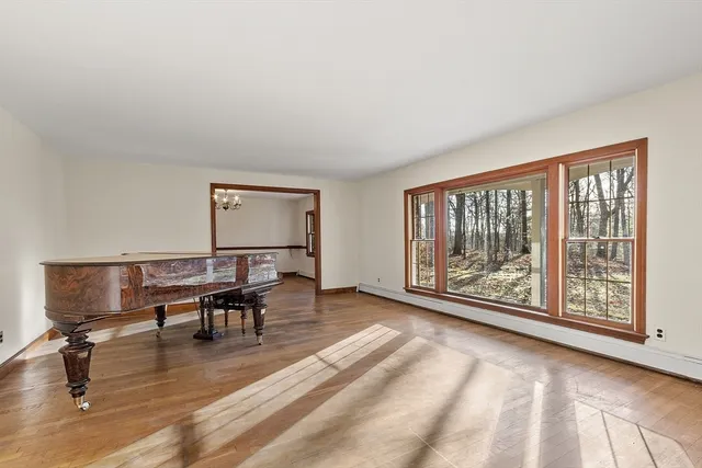 a living room with furniture and a floor to ceiling window