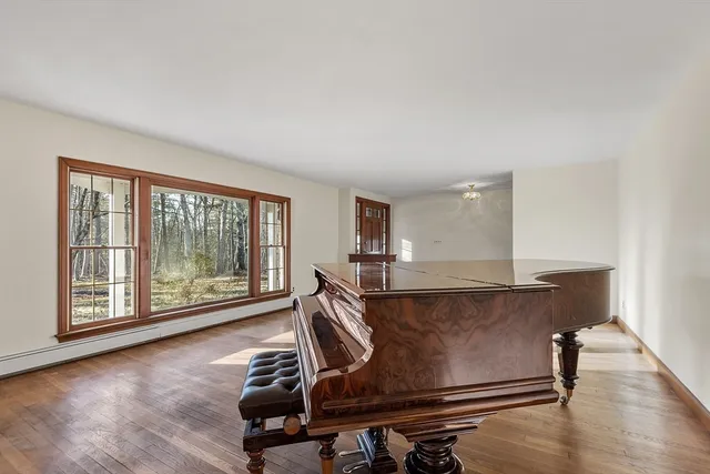 a living room with wooden floor and large window
