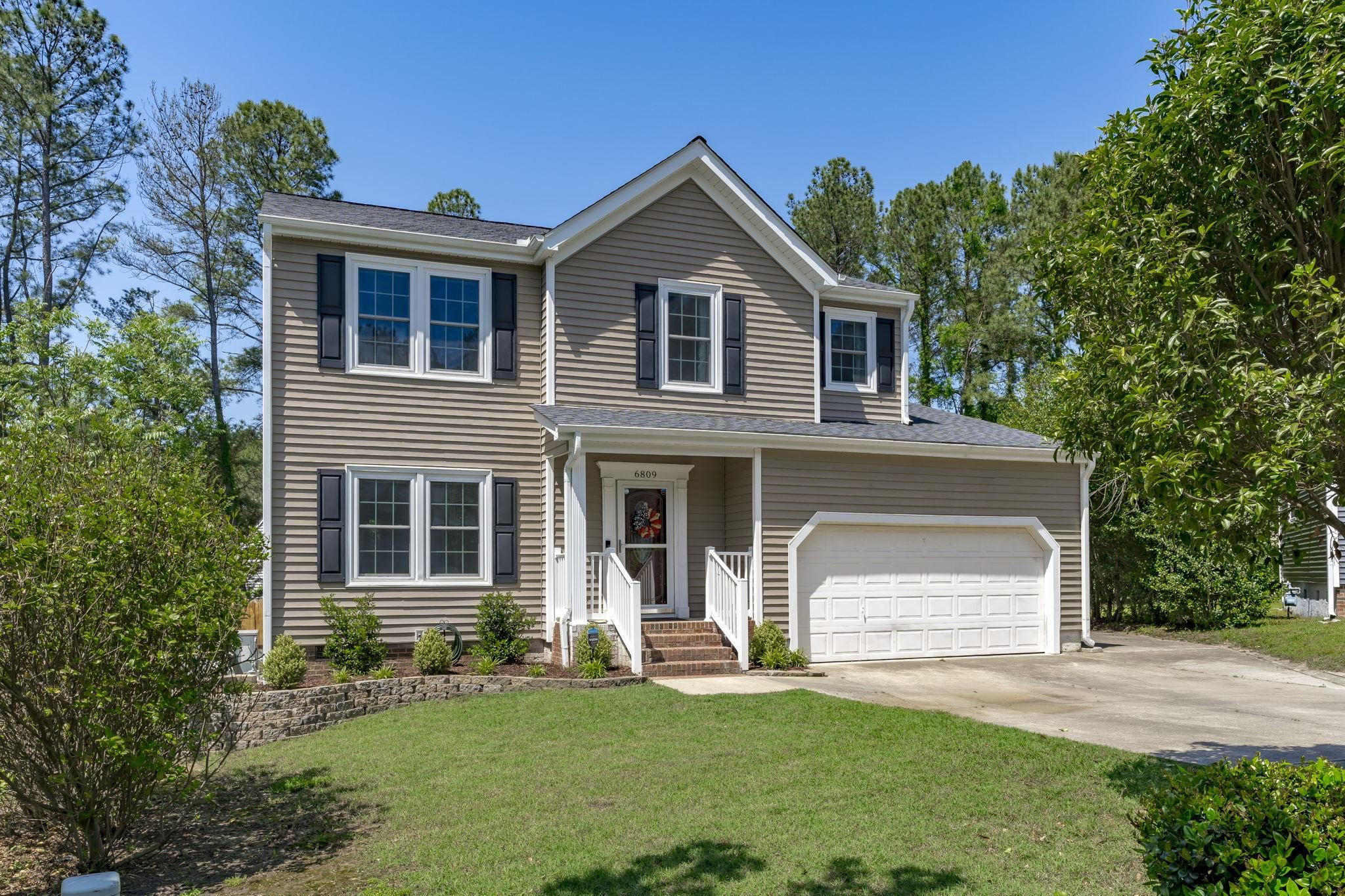 6809 Fereday Court Raleigh, NC 27616 - Photo 1 of 21 a front view of a house with a yard and garage