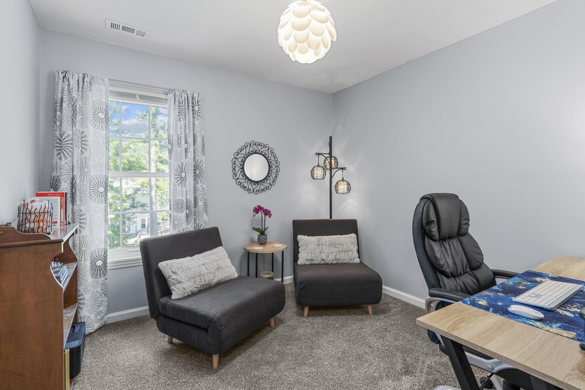 6809 Fereday Court Raleigh, NC 27616 - Photo 18 of 21 a living room with furniture a chandelier and a window
