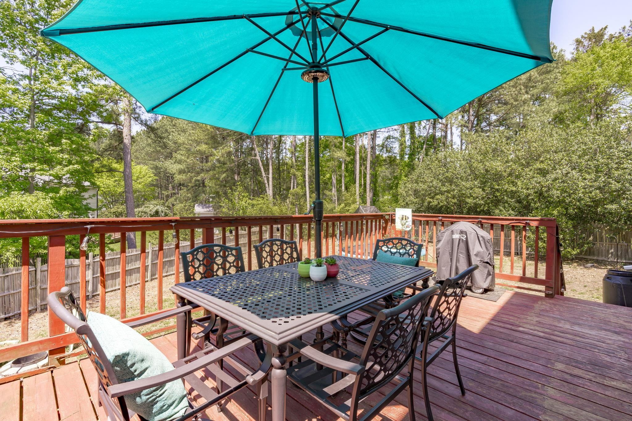 6809 Fereday Court Raleigh, NC 27616 - Photo 19 of 21 a balcony view with a table and chairs under an umbrella