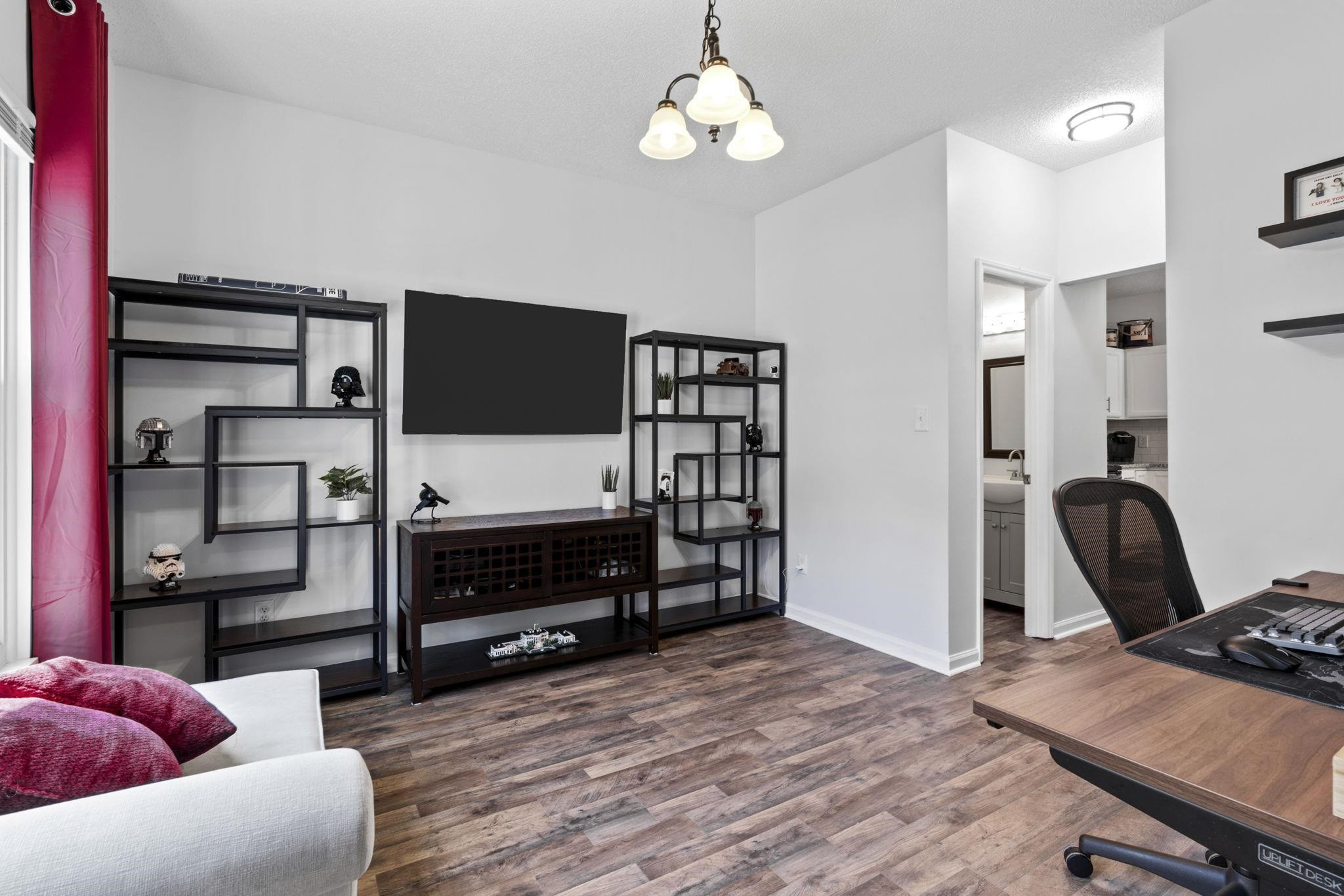 6809 Fereday Court Raleigh, NC 27616 - Photo 3 of 21 a view of a livingroom with furniture and a flat screen tv