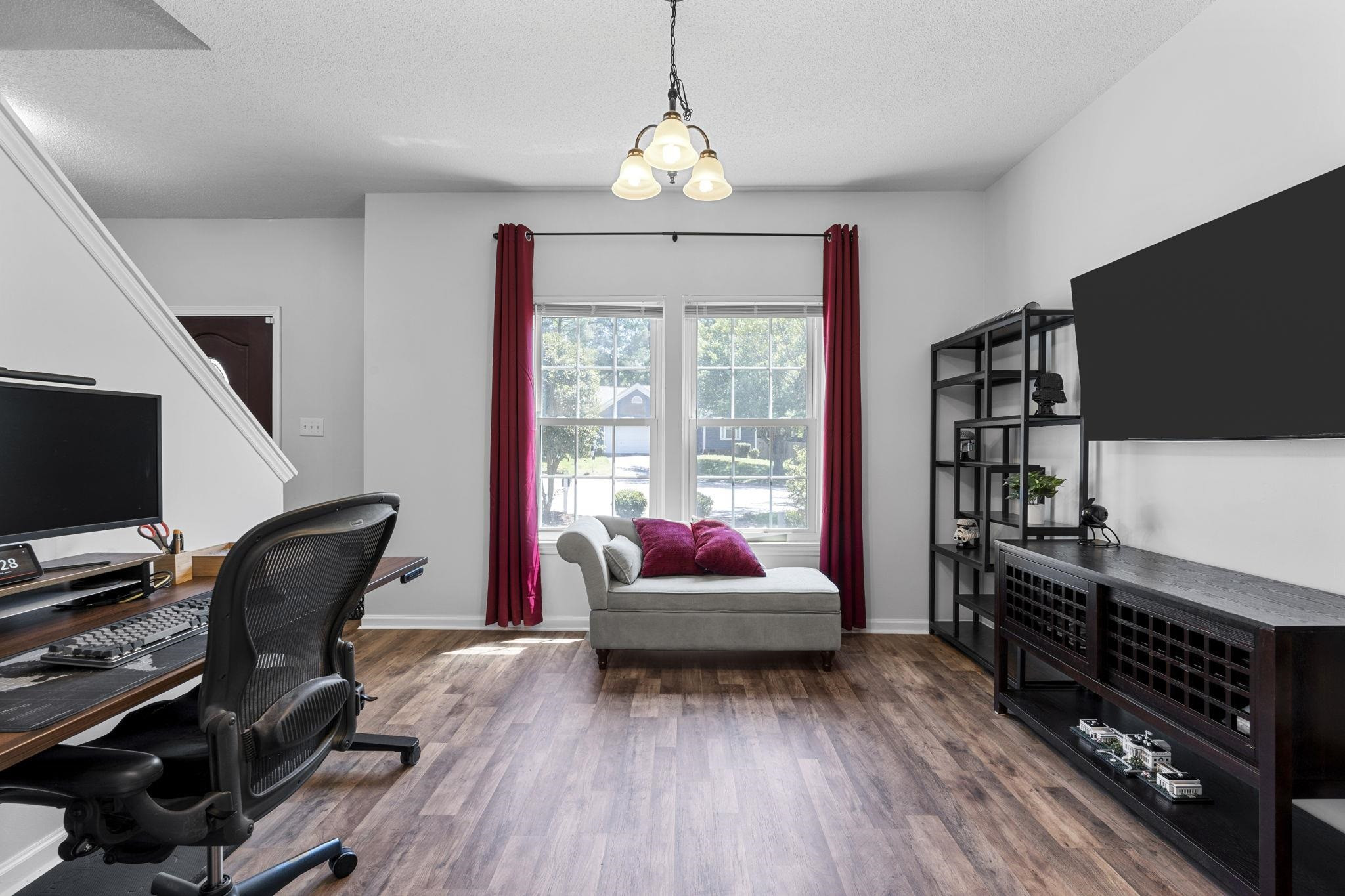 6809 Fereday Court Raleigh, NC 27616 - Photo 4 of 21 a living room with furniture and a flat screen tv