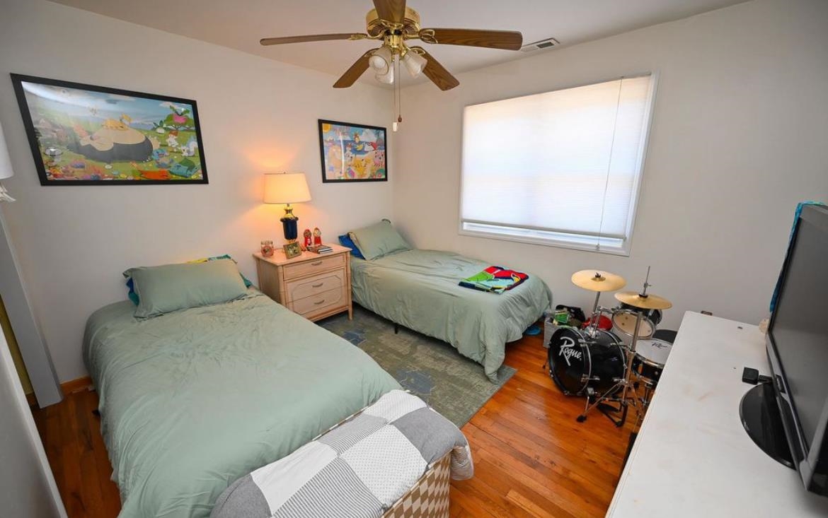 214 Sunray Road Del Haven, NJ 08251 - Photo 11 of 23 a bedroom with two beds and a chandelier