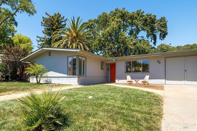 a house view with a sitting space and garden
