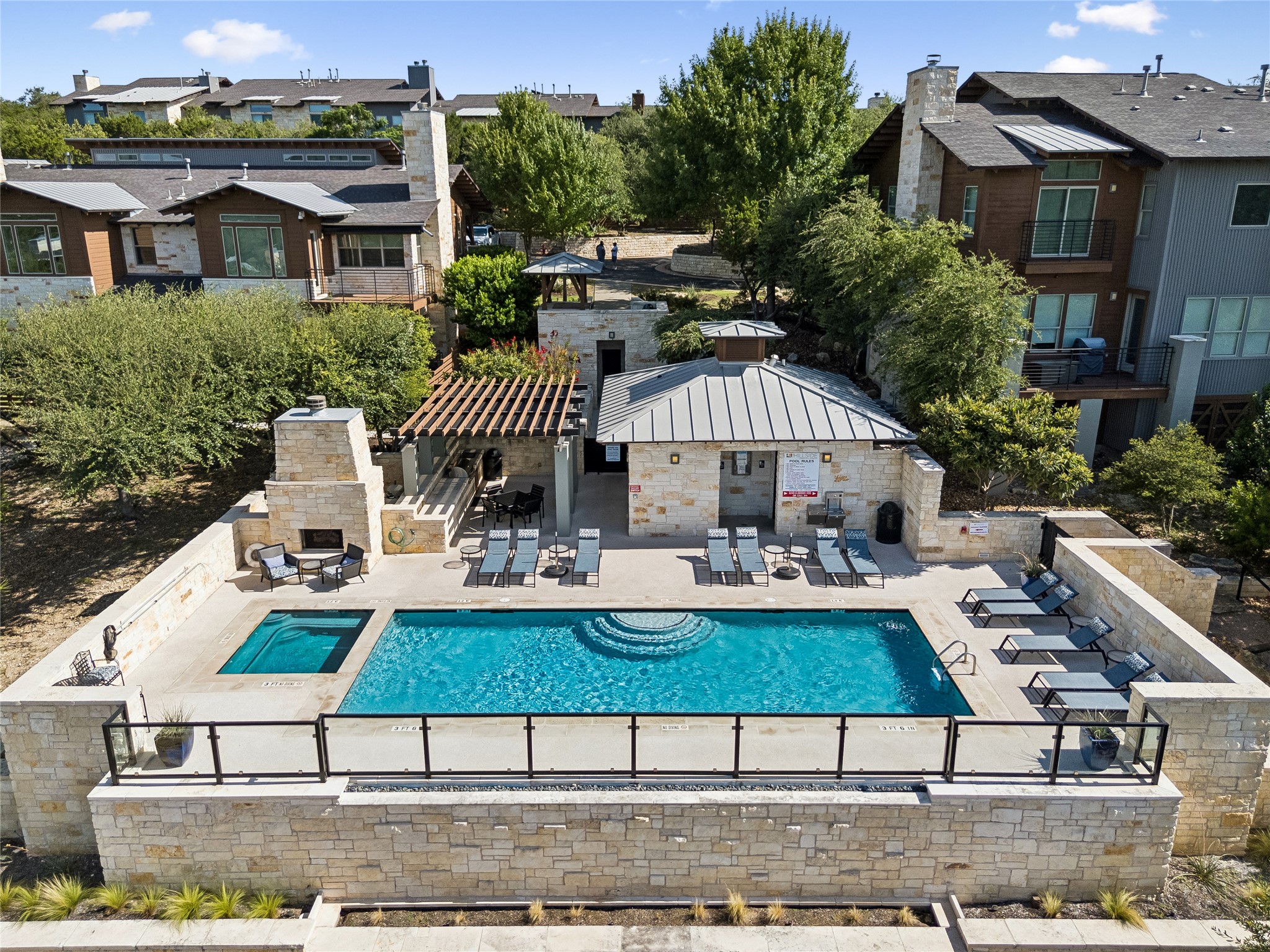 8110 Ranch Road 2222, Unit 68 Austin, TX 78730 - Photo 21 of 24 An inviting resort-style pool and hot tub await amidst lush surroundings.