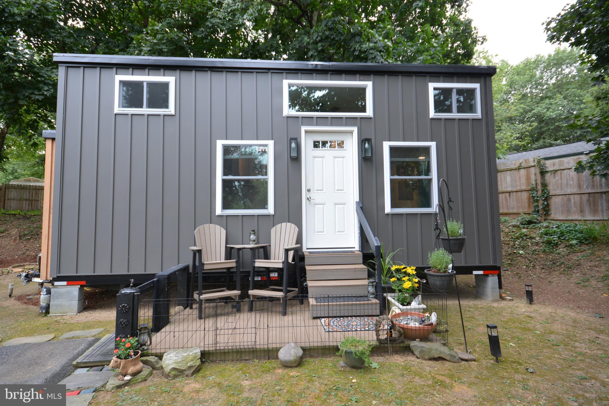 a view of backyard with a chair and tables