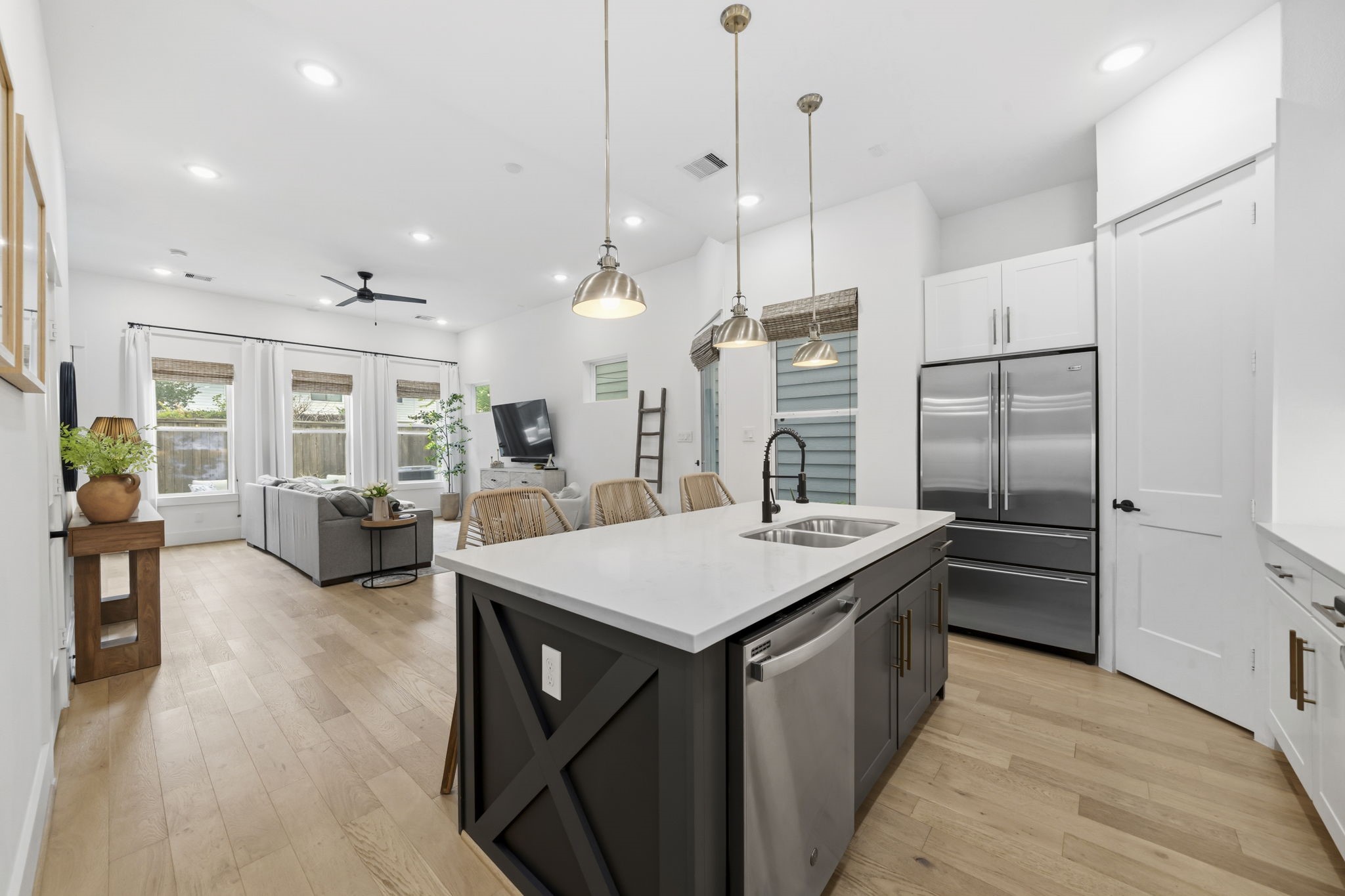 9018 Wellspring Drive Houston, TX 77080 - Photo 6 of 25 The open-concept layout allows for a seamless flow from the kitchen to the bright living area, perfect for entertaining guests while preparing meals.