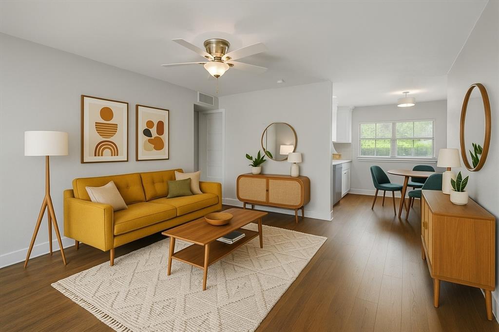 a living room with furniture and wooden floor