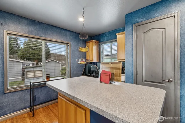 a kitchen with stainless steel appliances granite countertop a sink a stove and a refrigerator