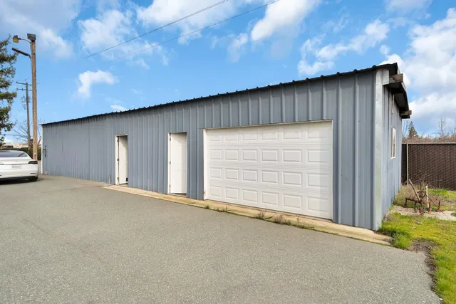 a view of a blue house with a large window