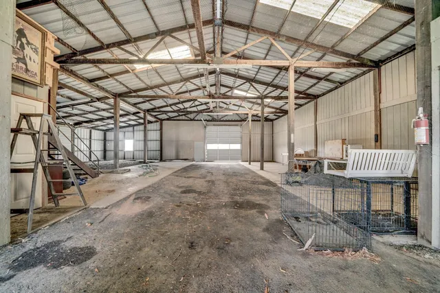 a view of a hallway with furniture and a window