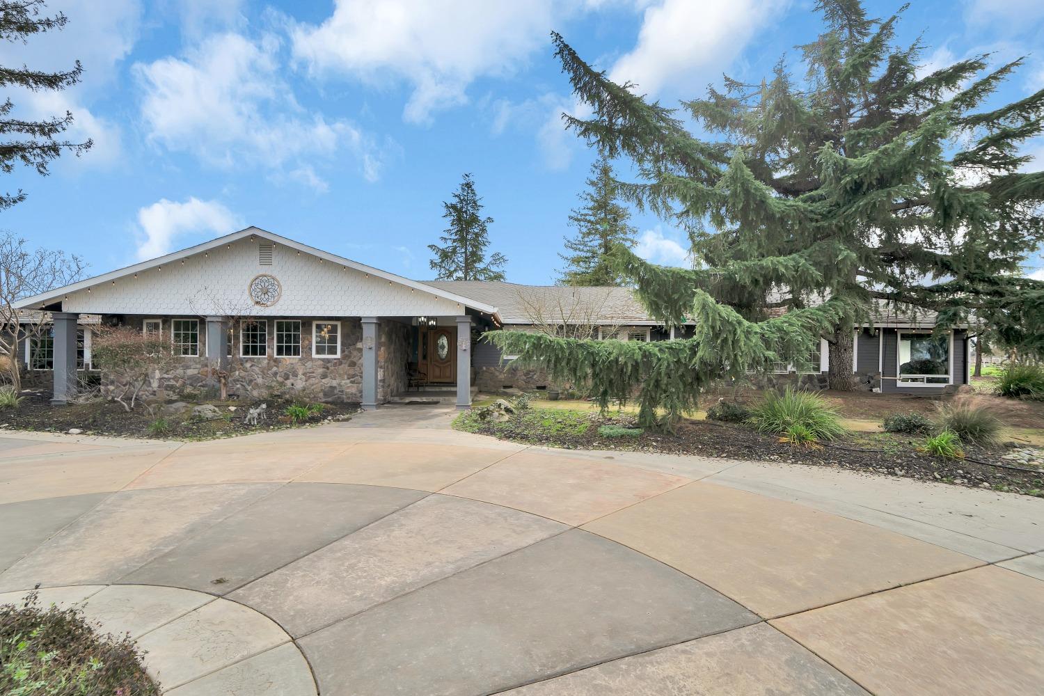 5420 East Jahant Road Galt, CA 95632 - Photo 2 of 73 a front view of a house with a yard and garage