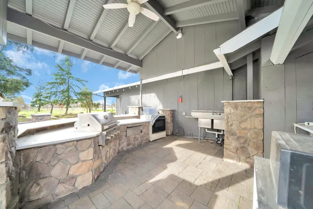 a kitchen with stainless steel appliances granite countertop a sink and a white cabinets