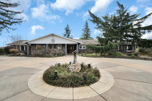 a front view of a house with garden