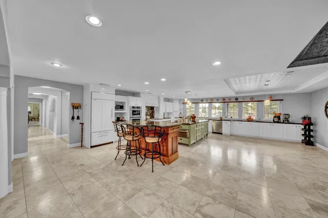 a view of a hallway with wooden floor and a potted plant