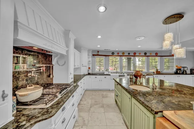 a kitchen with a sink cabinets and window