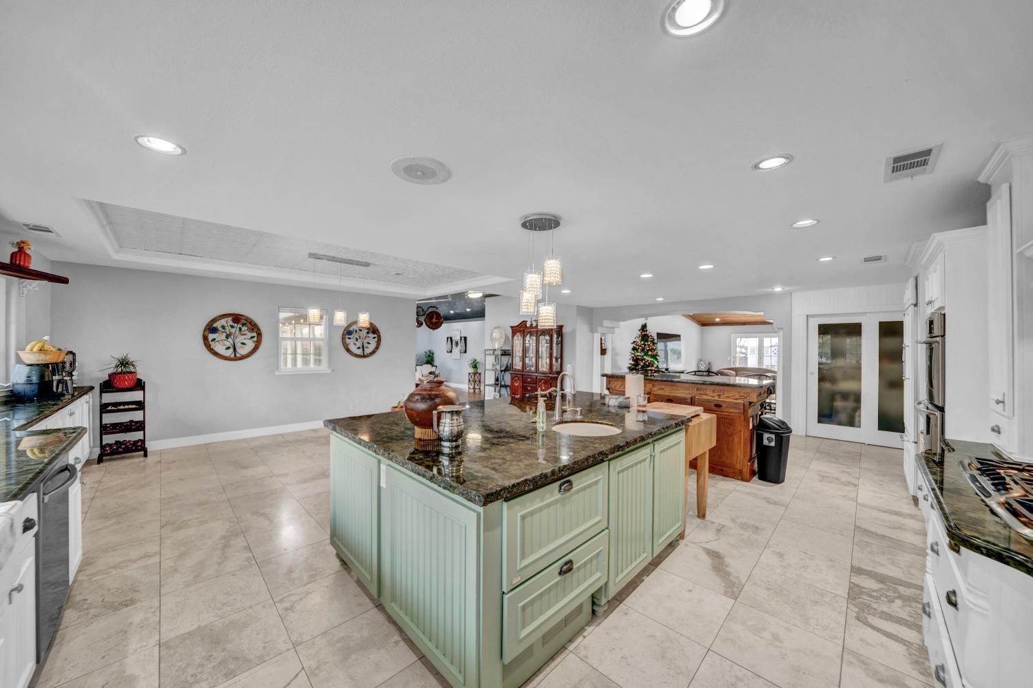 5420 East Jahant Road Galt, CA 95632 - Photo 43 of 73 a kitchen with stainless steel appliances granite countertop a sink and a white cabinets