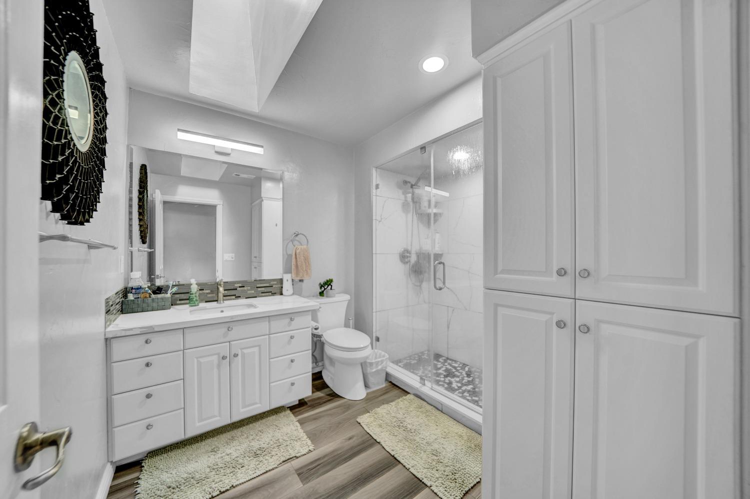 5420 East Jahant Road Galt, CA 95632 - Photo 57 of 73 a bathroom with a double vanity sink toilet mirror and bathtub