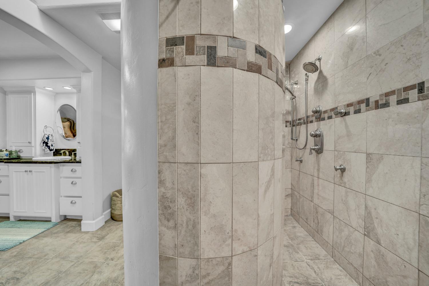 5420 East Jahant Road Galt, CA 95632 - Photo 63 of 73 a bathroom with a granite countertop sink a mirror and shower