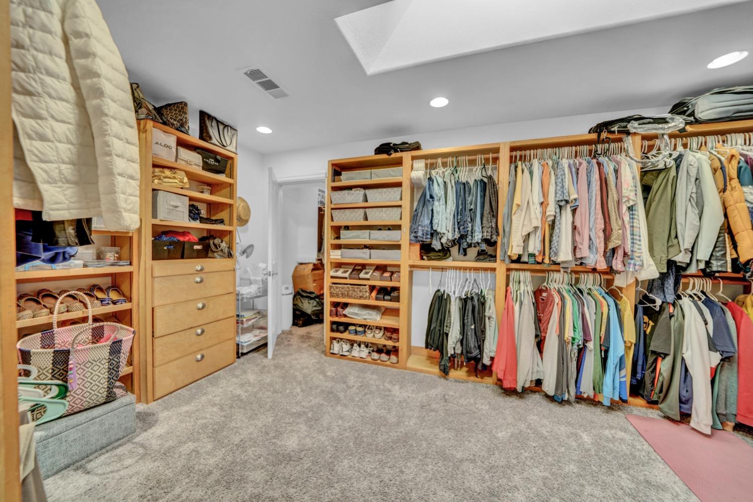 5420 East Jahant Road Galt, CA 95632 - Photo 65 of 73 a view of walk in closet with clothes and shoes
