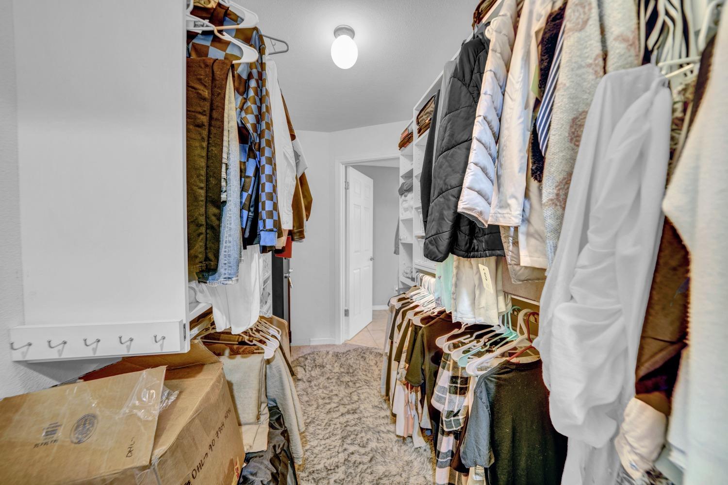 5420 East Jahant Road Galt, CA 95632 - Photo 66 of 73 a view of walk in closet with clothes and shoes