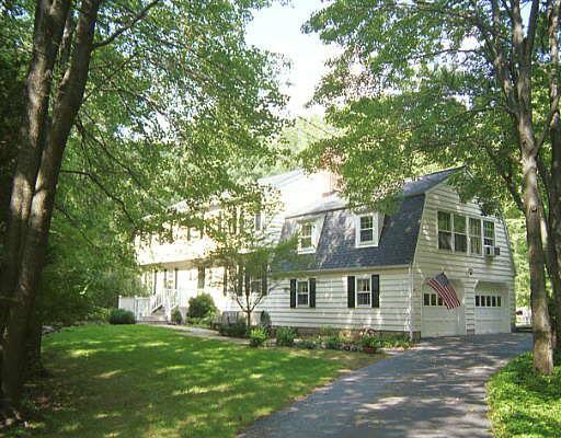 150 Pipers Hill Road Wilton, CT 06897 - Photo 1 of 1 a view of house in front of a big yard with large trees