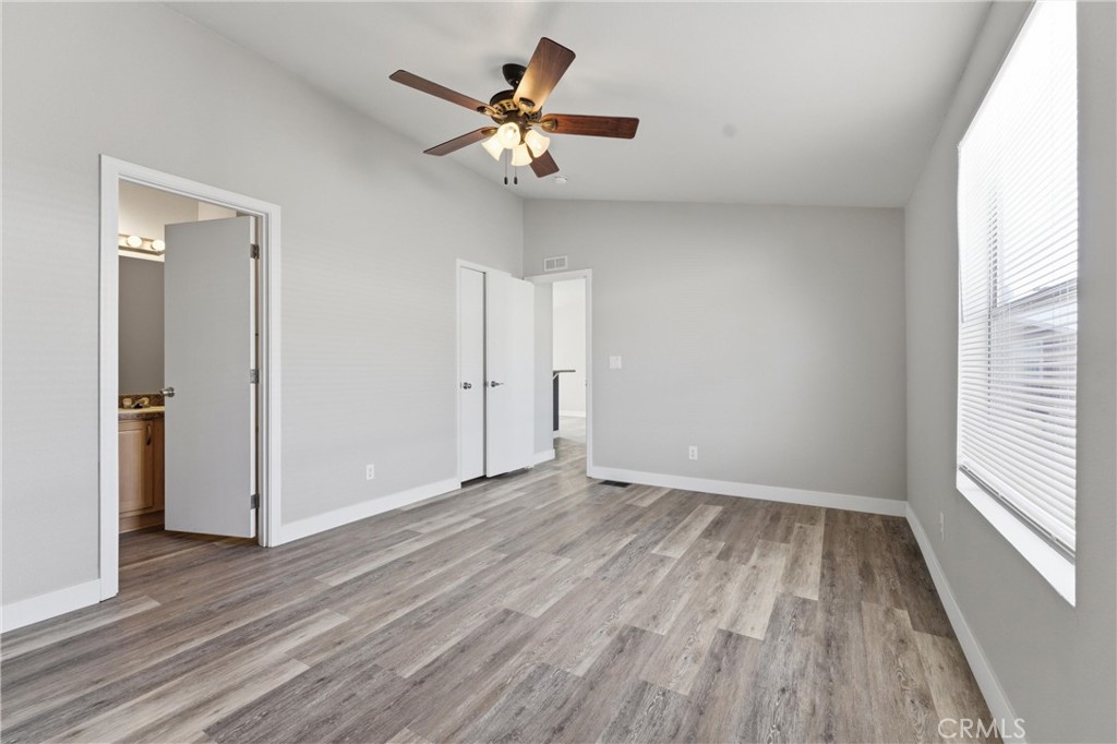 20843 Waalew Road, Unit C125 Apple Valley, CA 92307 - Photo 14 of 38 a view of a room with wooden floor and a ceiling fan