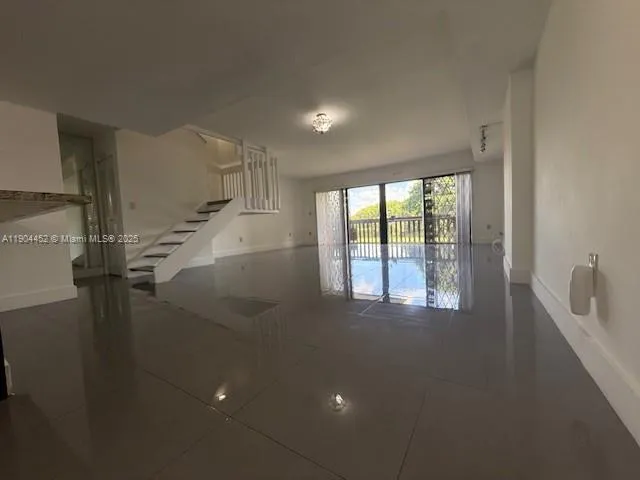 a view of a room with window and a ceiling fan