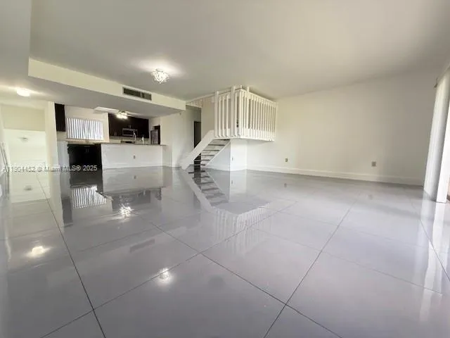 a view of kitchen with microwave and cabinets