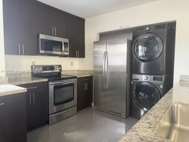 a kitchen with a sink and a refrigerator