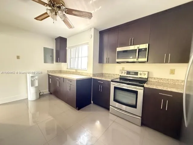 a kitchen with stainless steel appliances granite countertop a stove cabinets and microwave