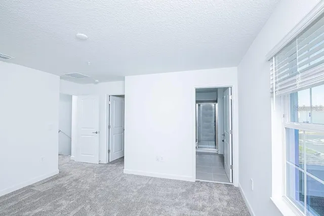 a view of an empty room with a window